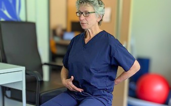 Exercise videos Person demonstrating a seated exercise in a therapy or rehabilitation setting.