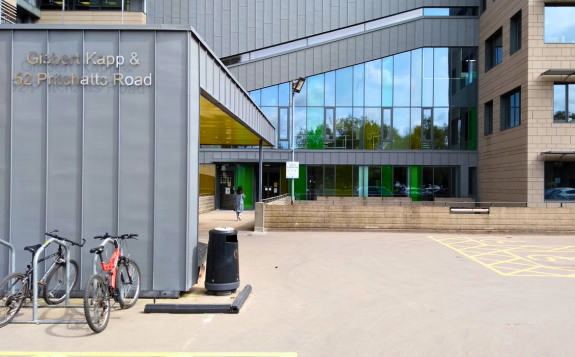 Brick building entrance to MD Support Centre Coventry with yellow-framed glass doors, signage displaying unit numbers 9 and 10, and a banner beside the doorway.